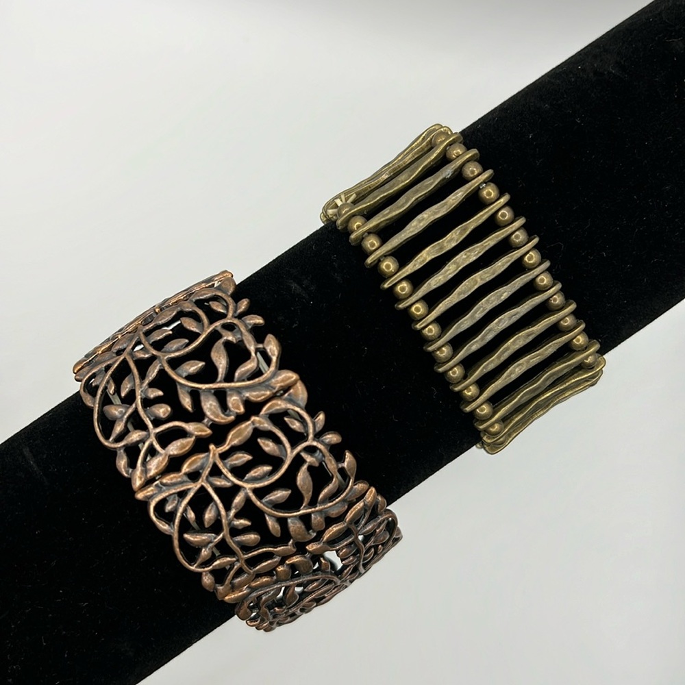Lot of two stretch bracelets. One is brass tone, and one is copper tone.